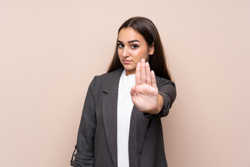 Young girl over isolated background making stop gesture with her hand