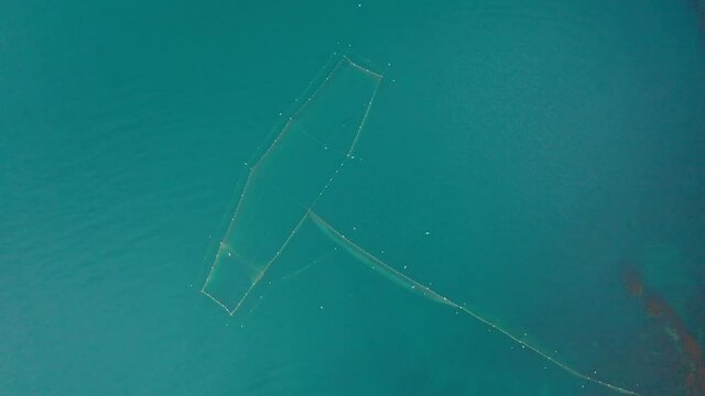 Drone flight above fishing nets in the sea water near the southern coast of the Black Sea, Bulgaria. Aerial drone view.