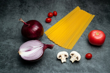 The delicious mushroom spaghetti is placed on the gray cement floor, and the Italian food is placed...