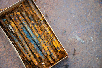metal stud, fasteOld metal studs covered in rust, close-up, selective focus.ning part, rust