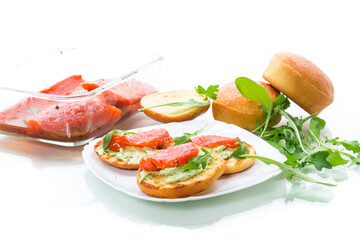sandwich with fried bun, cheese spread and red fish in a plate