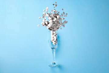 Champagne glass with confetti flat lay top view
