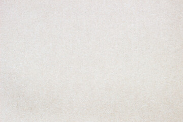Smooth surface of a cardboard sheet of uniform texture.