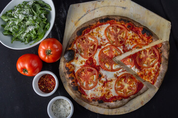 pizza with ingredients around it