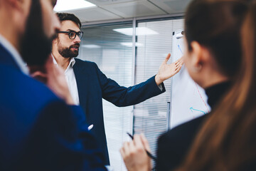 Proud ceo dressed in suit discussing financial graphic from flip chart analyzing profit strategy...