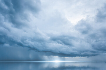 Dramatic blue sky at the sea with clouds reflection in water, Dark color, Ocean storm