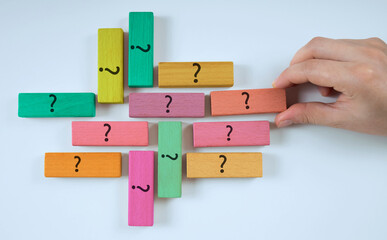 question marks on wooden cube. frequently asked questions concept