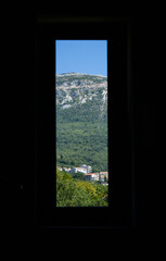 View from a rectangular window to the mountains of Montenegro