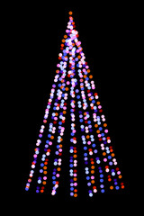 Fototapeta na wymiar Blurred christmas tree lights isolated on black background