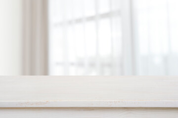 Table top for product display on blurred curtained window view