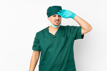 Surgeon in green uniform isolated on isolated white background with tired and sick expression