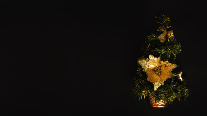 Christmas tree on a black background top view. Horizontal Christmas banner for the site. Copy space. Vintage muted style. The layout of the greeting card.