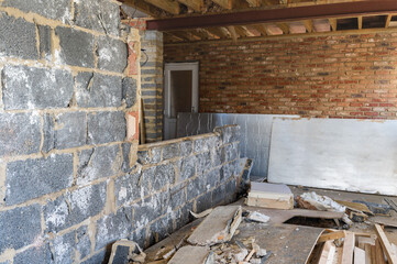 Demolition of the existing wall between the house and new extension. DIY renovation project, selective focus