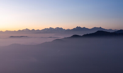 Fototapeta na wymiar Dawn in Himalayas. Pinkish morning view to Himalayan range from the top of Pikey peak. Nepal.