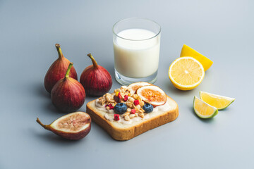 A healthy western breakfast with figs and toast and oatmeal.A western breakfast with fruit and milk