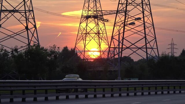 High-voltage power  line reliance at sunset