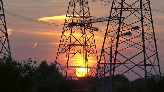 High-voltage power  line reliance at sunset