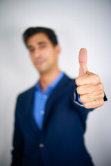 A businessman signalling a thumb up.