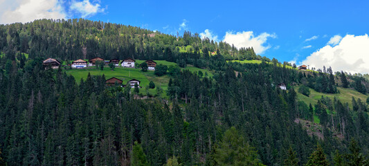 mountain farmsteads on a forest clearing on a hill slope in the Lesachvalley of Carinthia