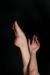 Fototapeta premium Smooth female legs on a black background
