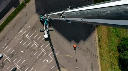 The tallest and largest mobile truck crane with extended boom, aerial top view.