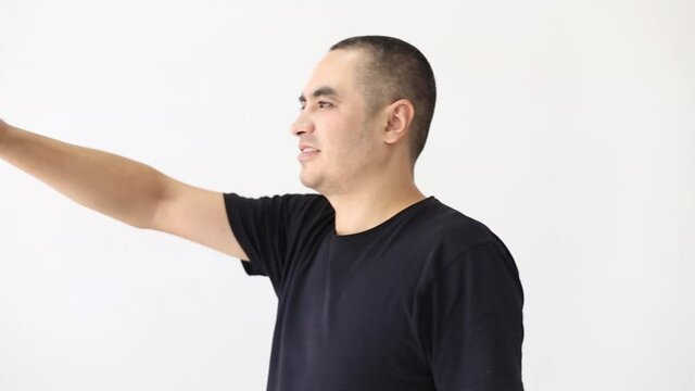 a man in a black t-shirt on a white background talking on the phone through the camera