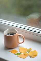 mug with coffee on the windowsill