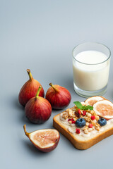 A healthy western breakfast with figs and toast and oatmeal.A western breakfast with fruit and milk