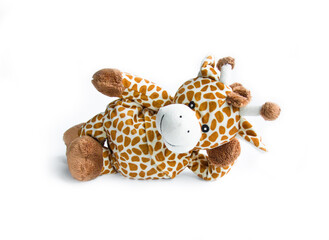 Plush toy giraffe isolated on a white background Colorful plush toy. Colored stuffed toy-giraffe. White and brown giraffe