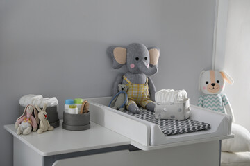 Modern changing table in baby room. Interior design