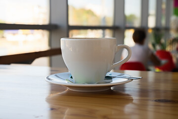 A cup of cappuccino on a table in a cafe. Morning coffee.
