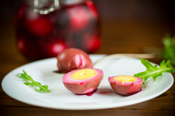marinated chicken eggs in beetroot marinade in a plate