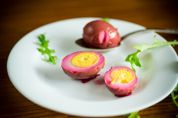 marinated chicken eggs in beetroot marinade in a plate