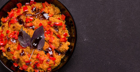Vegetarian dish. Soy meat with pepper and teriyaki sauce on a black background close-up. Copy space