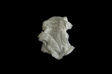 Used paper tissue on black background, top view