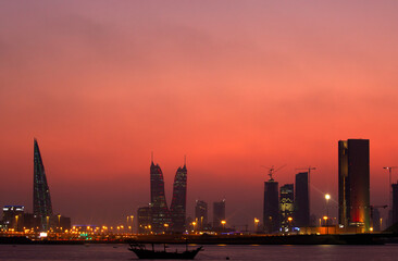 Fototapeta na wymiar MANAMA , BAHRAIN - DECEMBER 03: Bahrain Skyline and traditional dhow during sunset on December 03, 2019, Bahrain