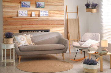 Stylish sofa and rocking chair in beautiful living room interior