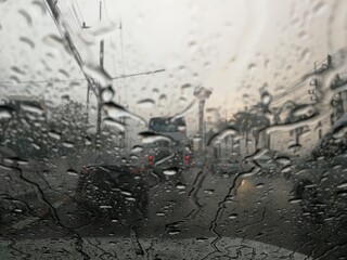 Road view through car window with rain drops, Driving in rain.