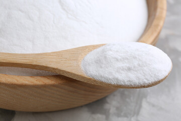 Baking soda on grey table, closeup view