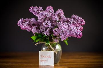 bouquet of beautiful spring flowers of lilac on the table