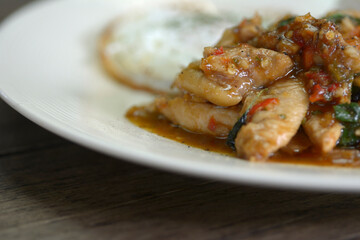 Stir Fried Thai basil with chicken and fried egg.