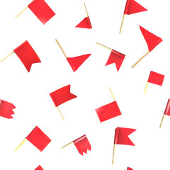 Seamless pattern with many small red flags on wooden skewers or toothpicks isolated on a white...