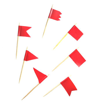 many small red flags on wooden skewers or toothpicks isolated on a white background