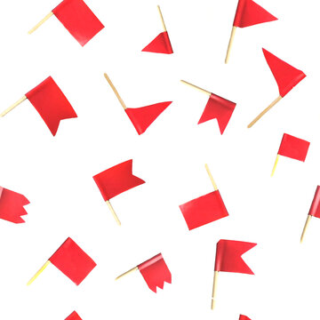 Seamless pattern with many small red flags on wooden skewers or toothpicks isolated on a white background. 
