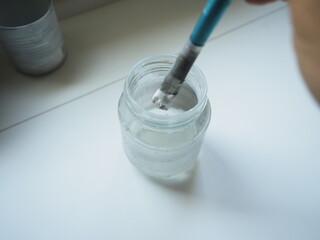 glass with a painting brush on it