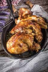 Quarters of fried chicken in a cast iron skillet.