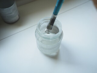 glass with a painting brush on it