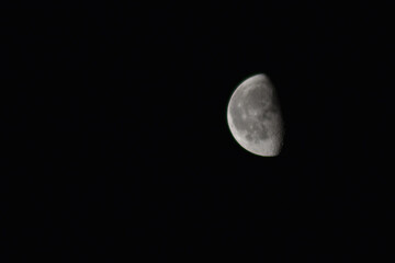 half the moon in the black sky