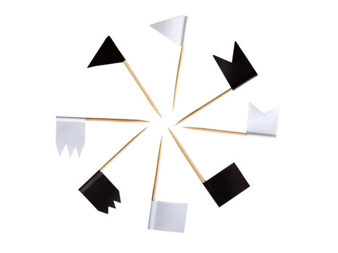 Black and white flags on wooden toothpicks isolated on a white background. Checkboxes of different shapes for account training. Accessories for decorating baked goods.