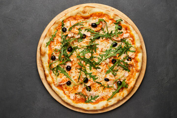 Delicious Italian seafood pizza on dark background